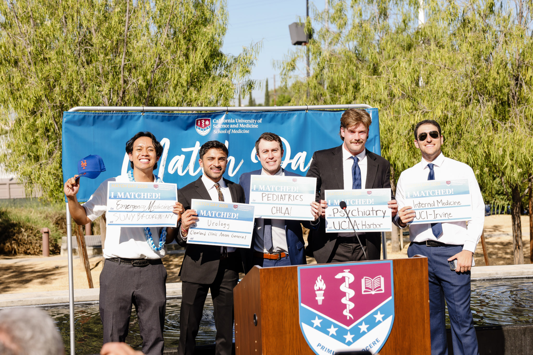 Students at podium sharing I matched sign
